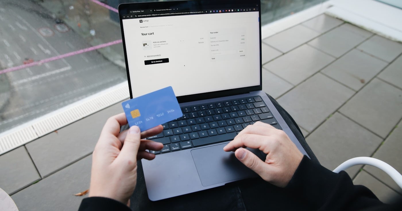 Person finalizing an online purchase with credit card — buy now pay later checkout