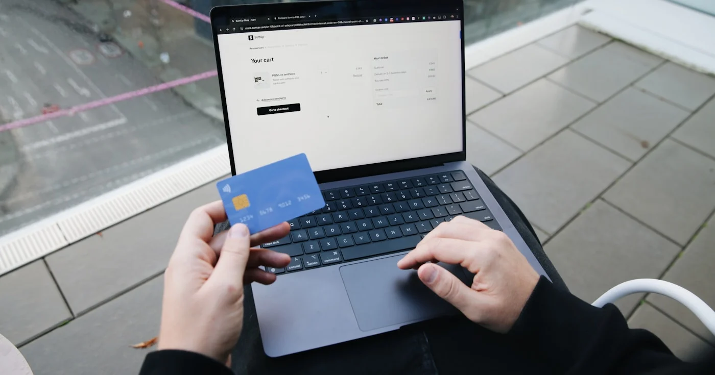 Person finalizing an online purchase with credit card — buy now pay later checkout